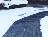 Asphalt driveway retrofitted with radiant snow melting cable