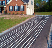 Snow melting cable being installed in asphalt driveway